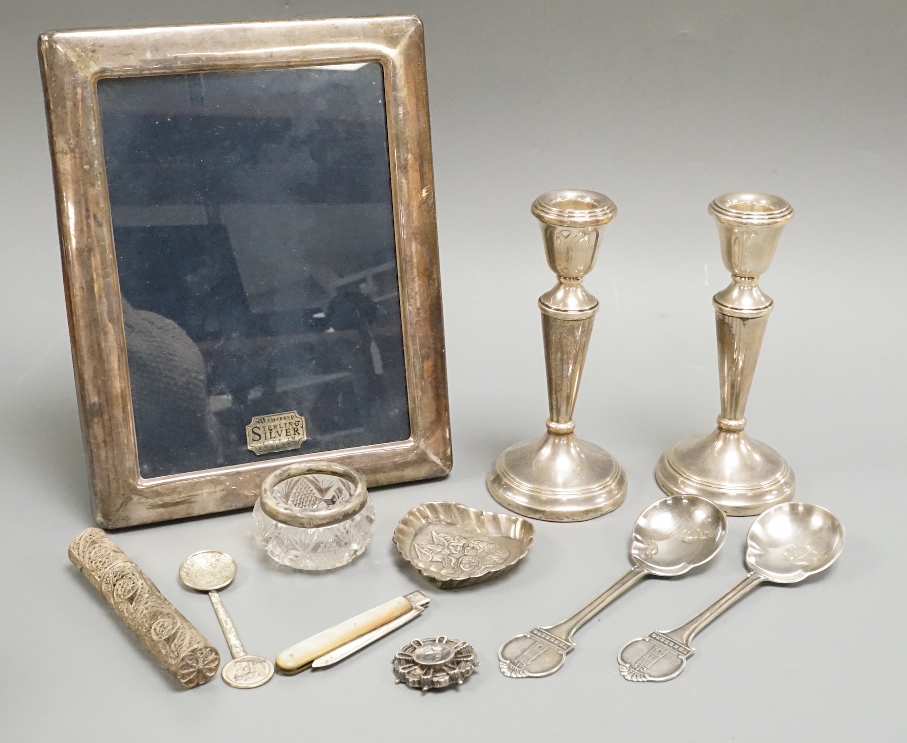 Sundry silver and white metal including a pair of modern candlesticks and a similar photograph frame.